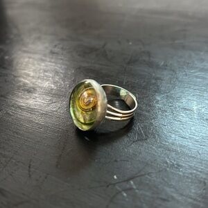 Round statement ring silver toned base glass top with green amber swirl pattern